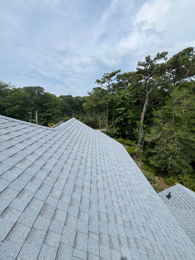 Finished roof ridge and hip lines on light gray shingles