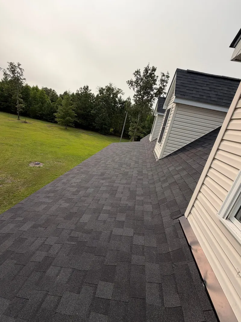Finished charcoal shingle roof with dormers