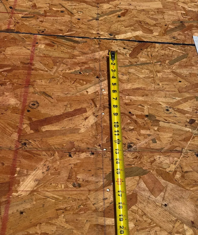Measuring fastener spacing along a chalk line on an OSB roof deck