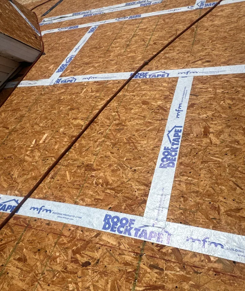 White roof deck tape sealing the seams of an OSB roof deck