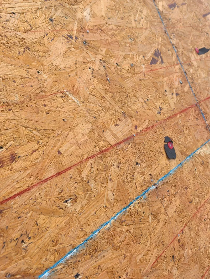 Close-up of fasteners along chalk lines on a roof deck panel