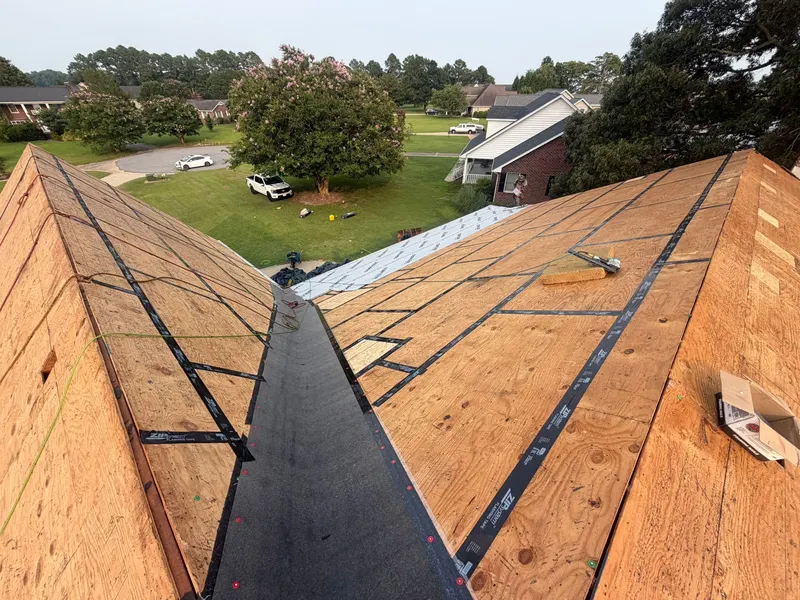 Taped deck seams on both sides of a roof valley