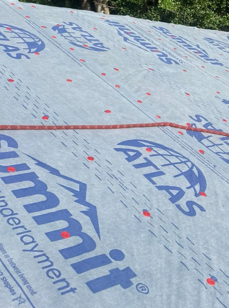 Synthetic roof underlayment fastened with plastic cap nails